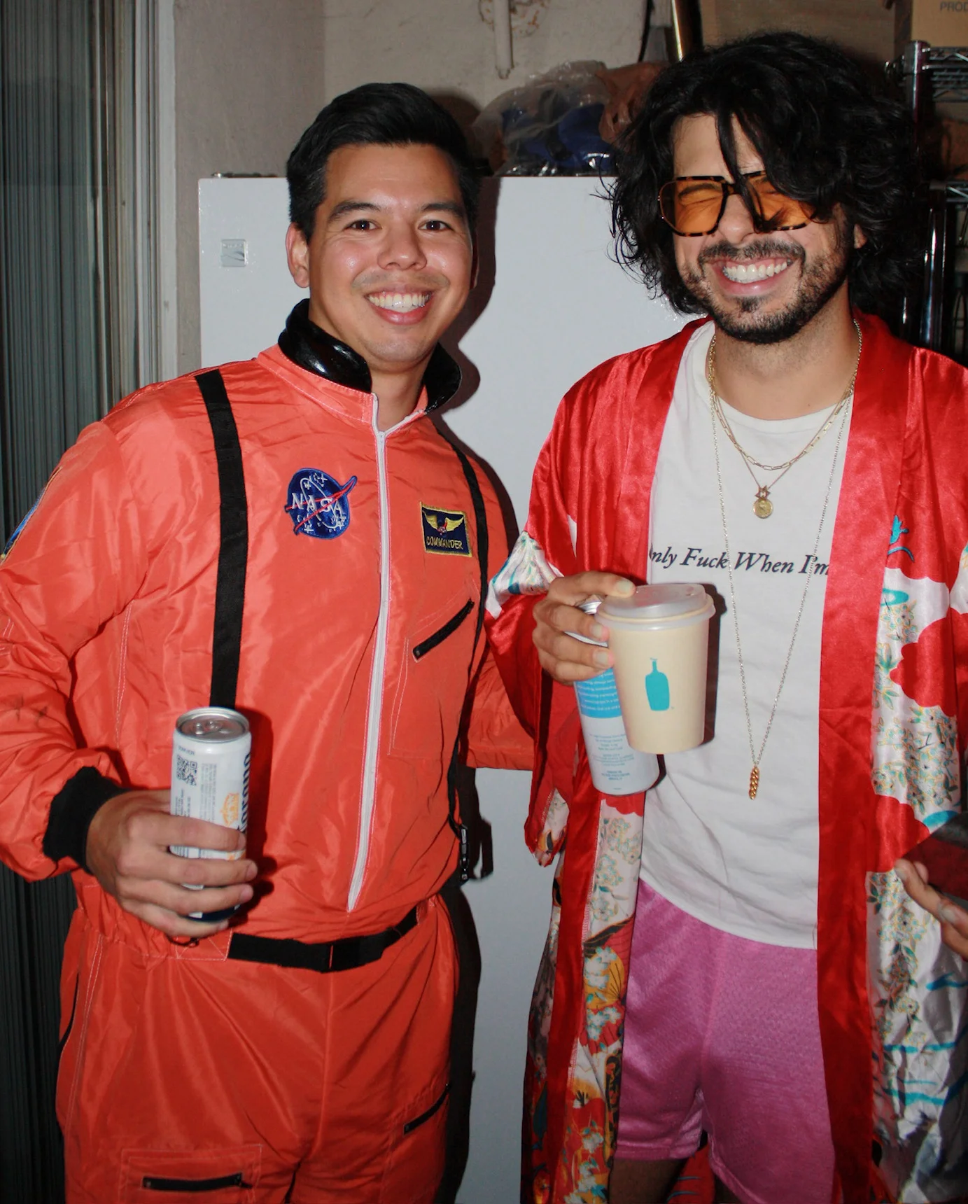 Two friends smiling together at a Halloween party